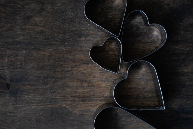 Heart shaped cookie cutters on wooden table