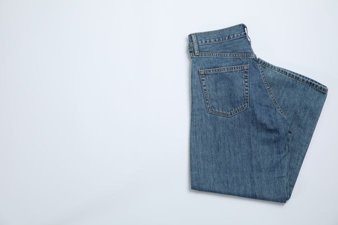 Jeans on light background, space for text