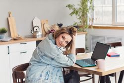 Freelancer Workplace At Kitchen Table With Laptop