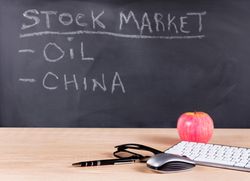 Desktop setup for studying investments with chalkboard