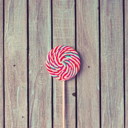 Large swirling lollipop on wood background