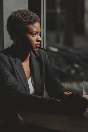 Smiling stylish Black woman in cafe