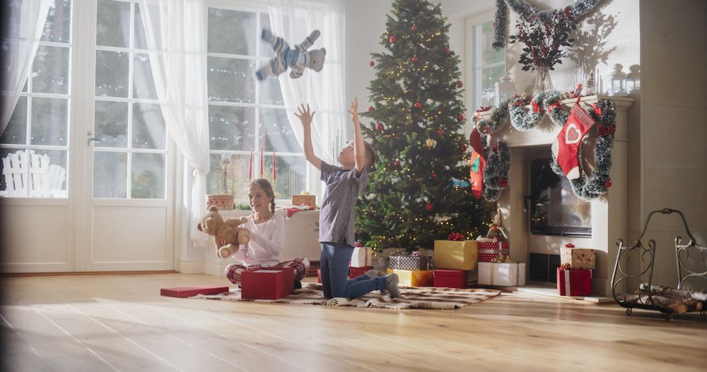 Happy Little Boy and Girl Waking Up on Holiday Morning to Receive New Toys