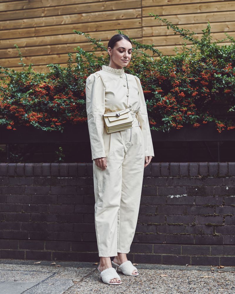 London, England, United Kingdom - September 18 2021: Woman in head to toe beige looking down
