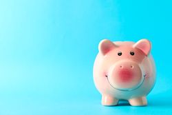 Happy piggy bank on color background, space for text. Finance, saving money