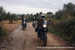 Group of friends going for a bike ride on a dirt road 0gPej5