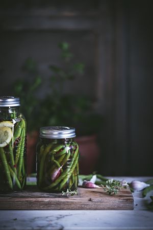 Fresh green vegetables with fruits and glass jars