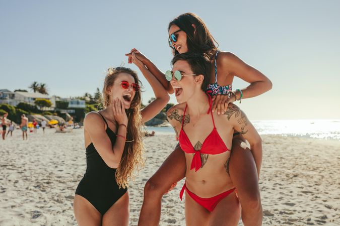 Group of playful women having fun at the beach