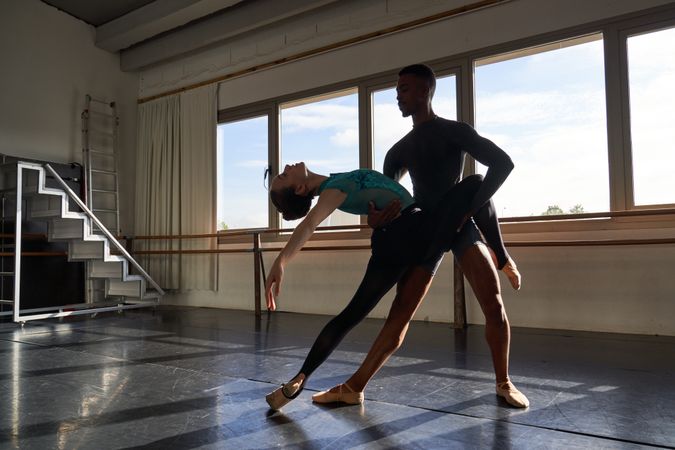 Couple of two dancers in a class doing a training in ballet academy