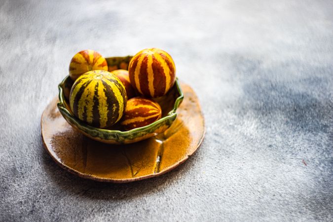 Organic mini melons in bowl with copy space