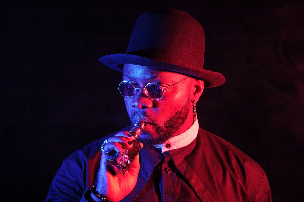 Stylish Black man with vaping mod