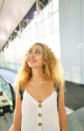 woman walking in spacious hall in sunlight