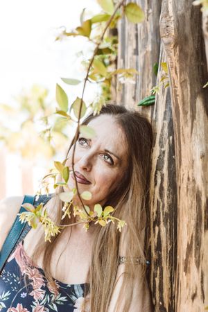 Adult woman behind tree twig
