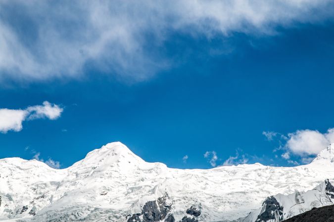 Snowy mountains under a blue sky on sunny day in Fairy Meadows, Pakistan