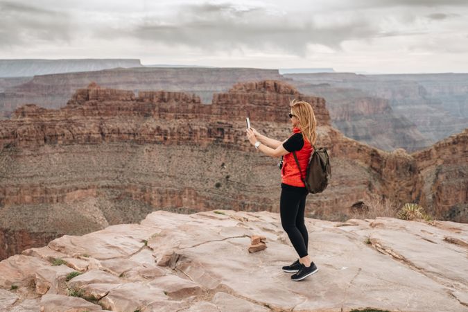 Active female photographing pictorial landscape