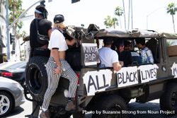 Los Angeles, CA, USA — June 14th, 2020: people ride in Army truck at All Black Lives Matter protest 4d8kd4