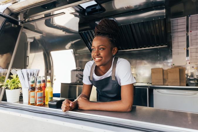 Female server smiling in food truck window