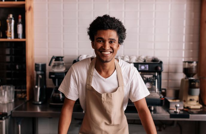 Man in apron looking at camera and smiling