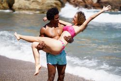 Loving man holding woman on the coast