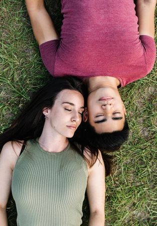Looking down and young man and woman lying on the grass