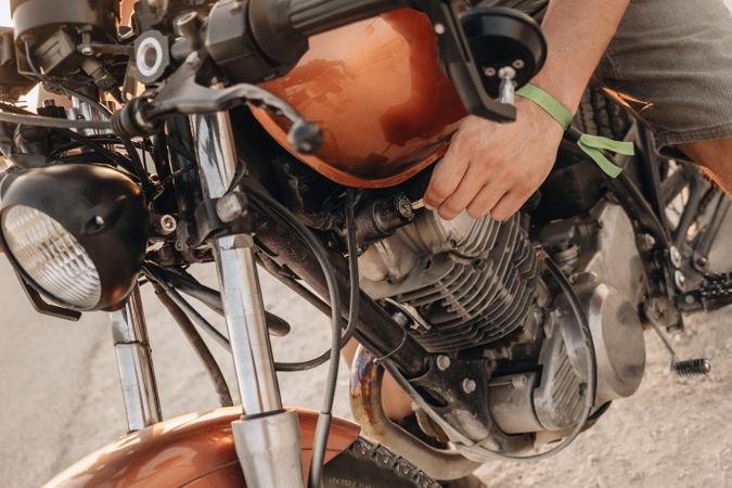 Male driving moto on asphalt