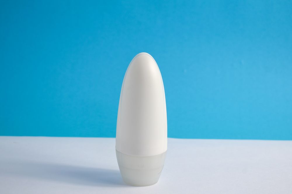Mock up cosmetic bottle on counter with blue background