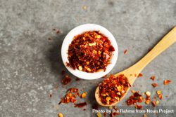 Bowl of chili flakes on marble table 0Pxre0