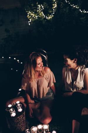 Couple with candles resting in night garden