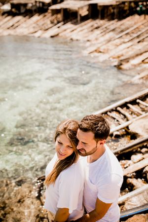 Happy lovers cuddling at cove