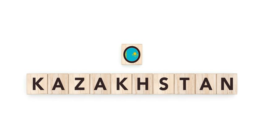 Wooden blocks bearing the name and flag of Kazakhstan. Kazakh and Asian Culture, national identity, travel, and geography in a copy space design.