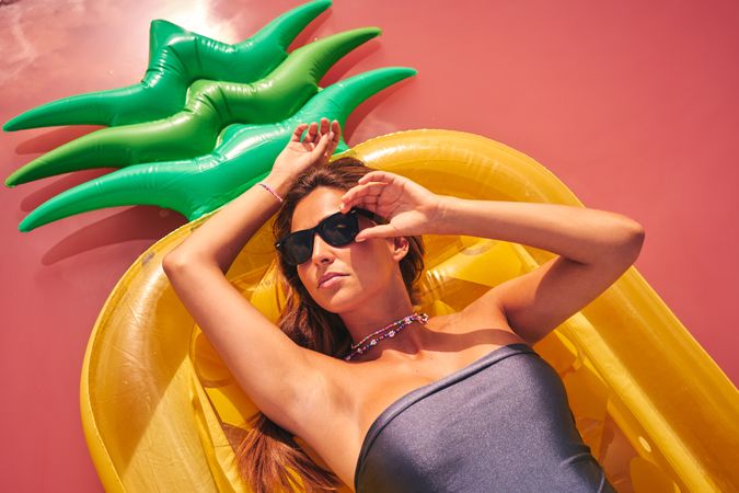 Dreamy female resting on inflatable mattress