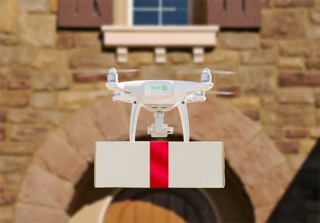 Drone Delivering Red Ribbon Wrapped Package to House Porch