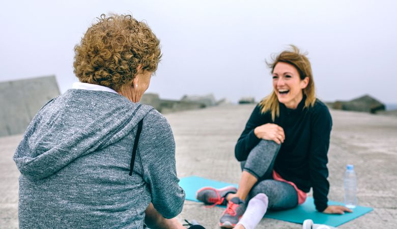 Sportswoman laughing with Older woman