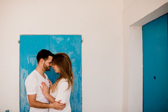 Loving couple cuddling near beach house