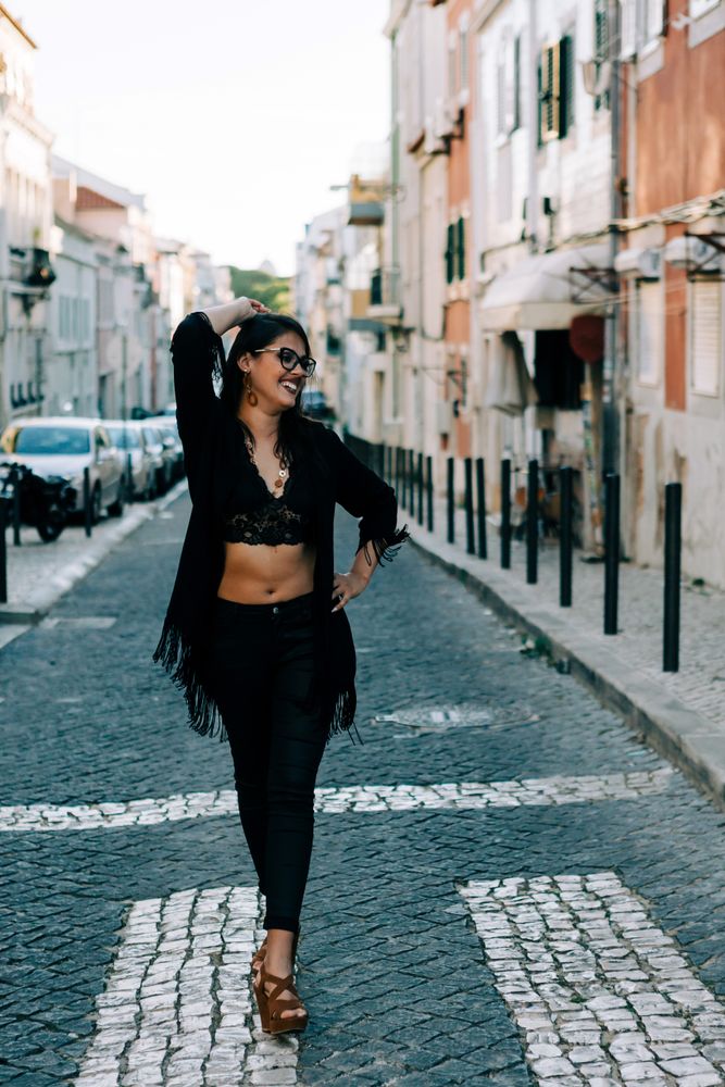 Joyful trendy female in old town street