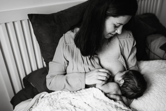Mom breastfeeding at home