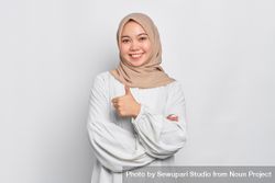 Asian female in headscarf with one thumb up bYxj14