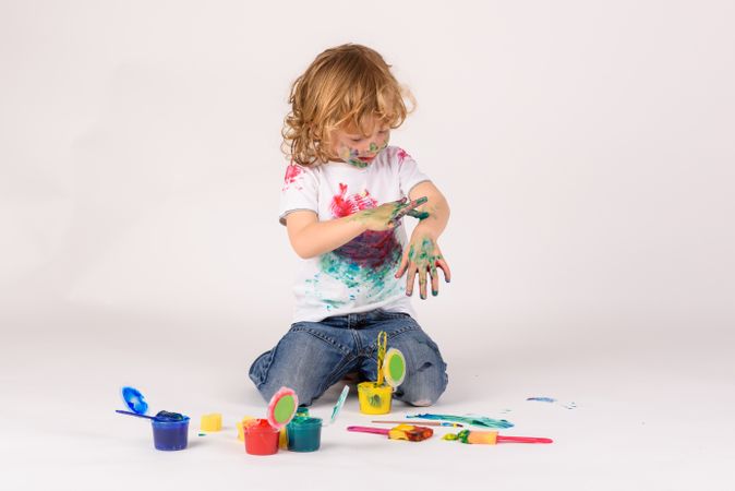 Boy covered with colorful paints