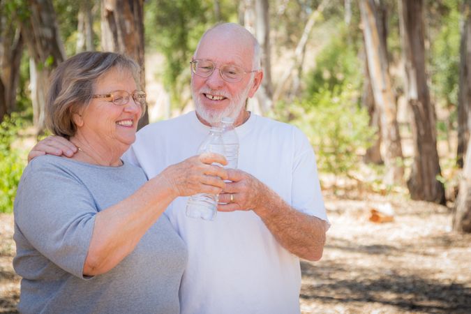 Happy Healthy Mature Couple with Water Bottles