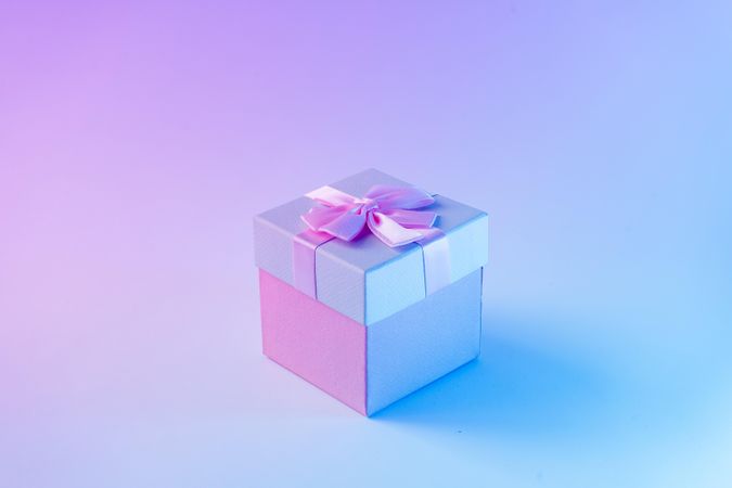 Wrapped present on vibrant bold gradient holographic colors