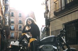 Young woman in custom motorbike