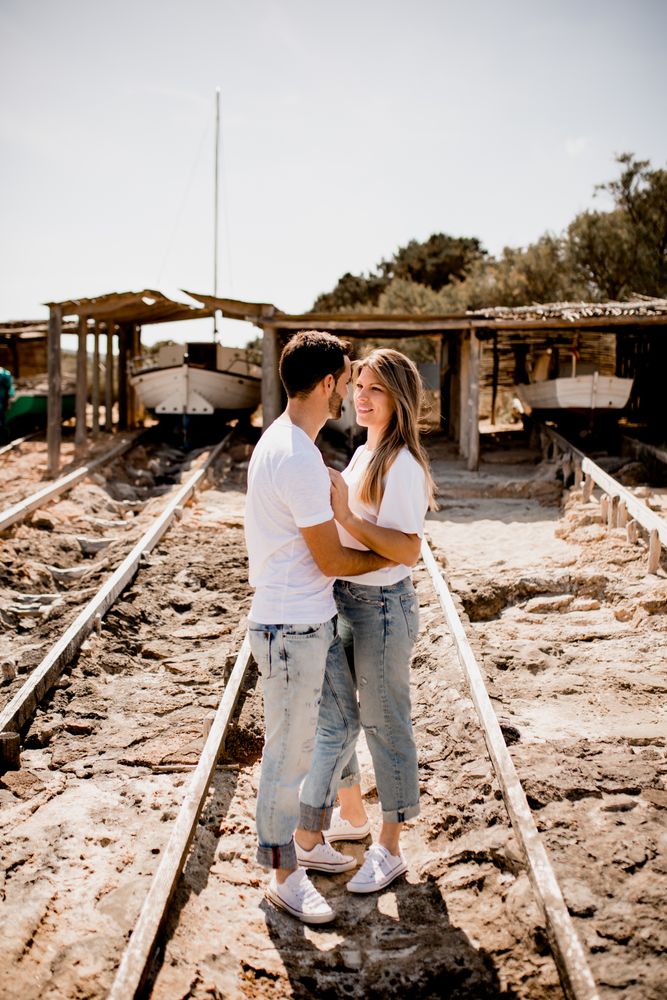 Delighted lovers hugging at rails in dock