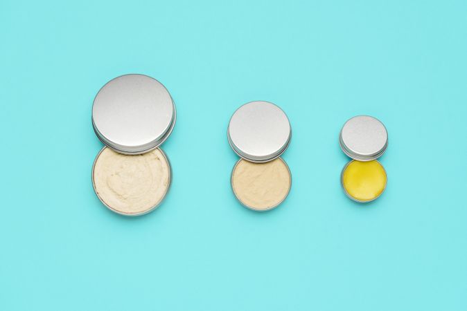 Natural cosmetics in metal cans, isolated on a blue background