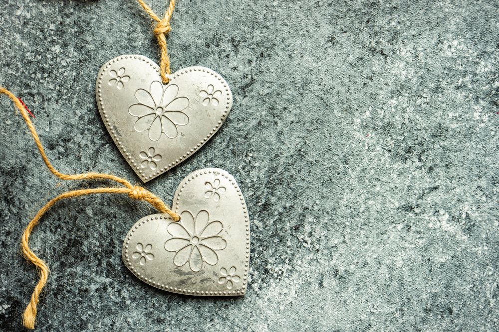 Valentine's day concept with close up of heart shaped ornaments on grey counter