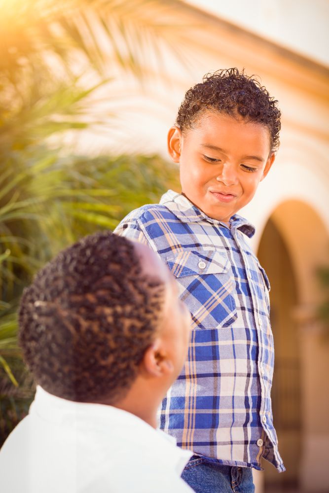Black Son Playing With Father Outdoors