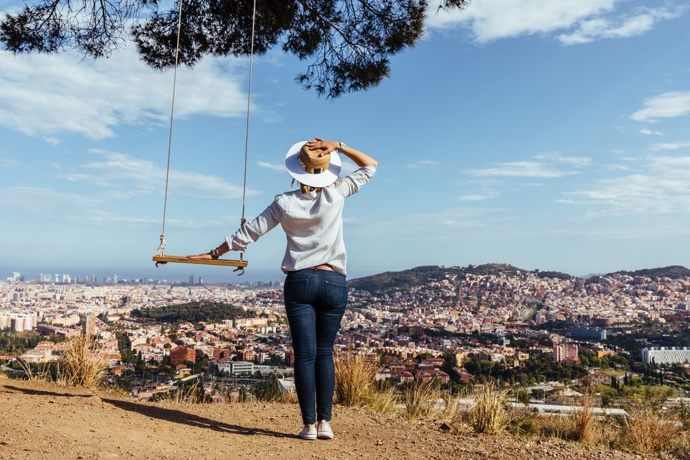Woman with hat watching the city