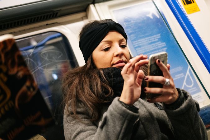 Woman using smartphone in train