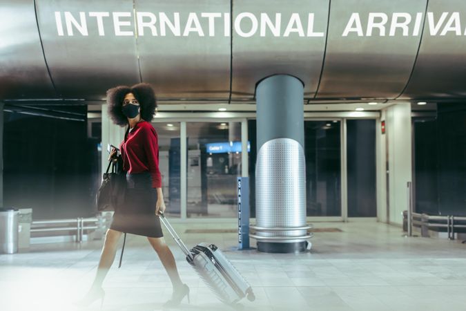 Businesswoman walking through airport terminal