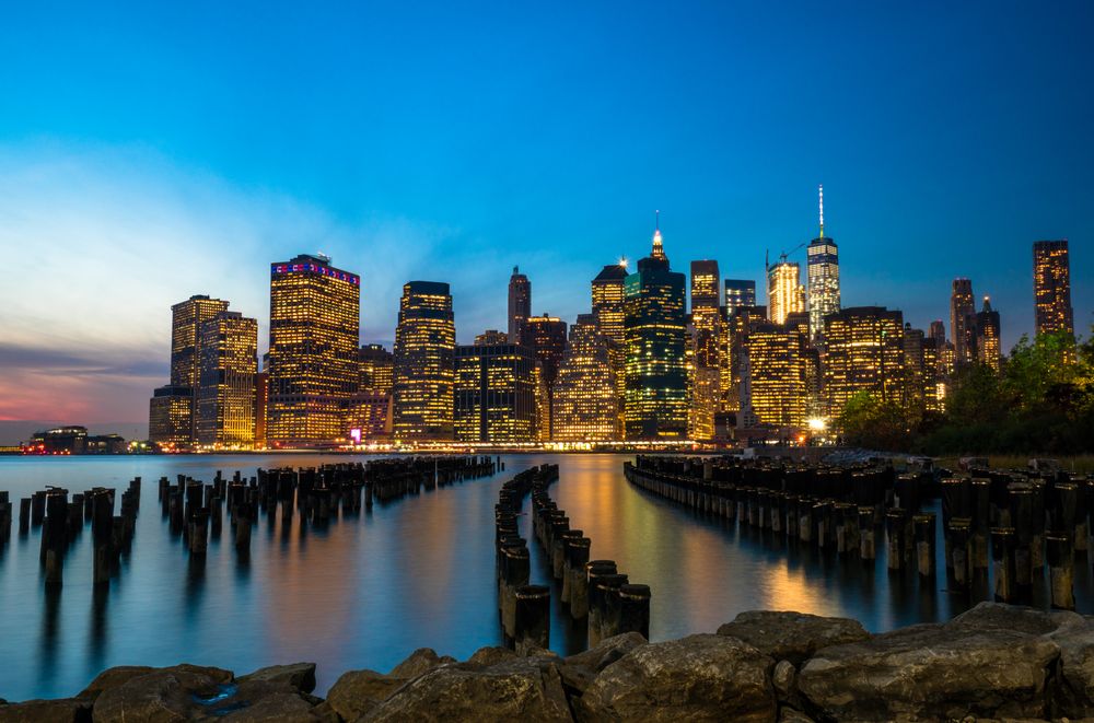 City skyline across body of water during nighttime