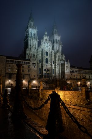 Santiago de Compostela Cathedral view at misty foggy night after rain. Cathedral of Saint James pilgrimage. Galicia, Spain